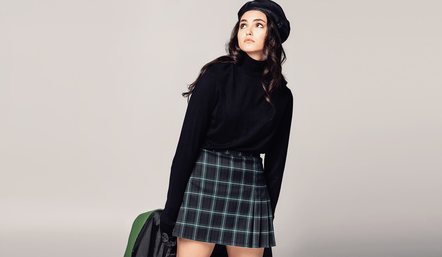 A woman in a Dark Academia sweater and skirt