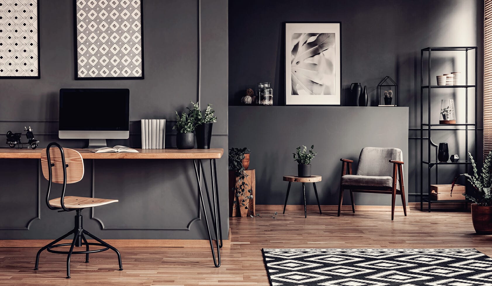 Moody grey monochromatic home office with black and wood industrial furniture.