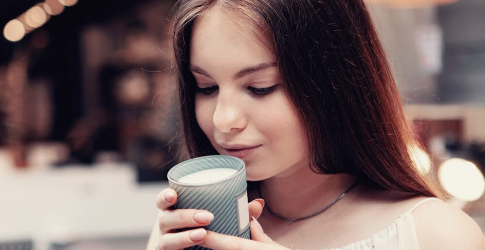 A girl smelling a candle